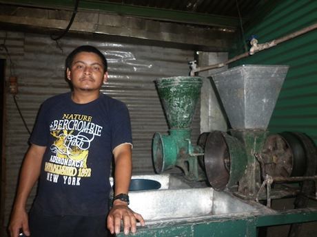 photo of Manuel De Jesus in front of his milling equipment